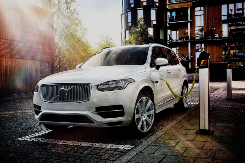 White Volvo plugged into EV Charger Station